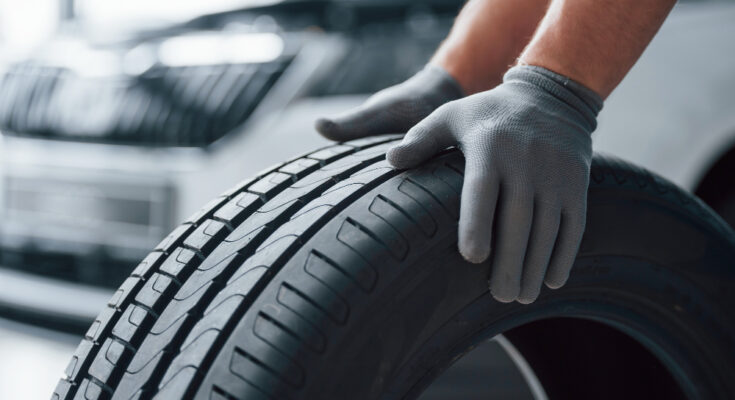 Hands Only Mechanic Holding Tire Repair Garage Replacement Winter Summer Tires