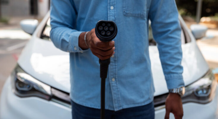 Front View Man Holding Car Charger