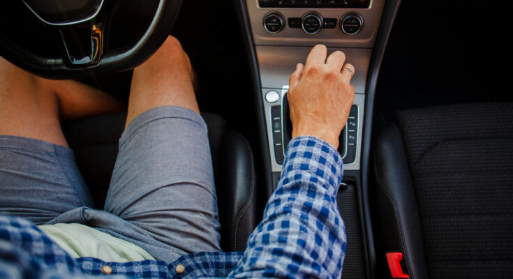 Man Shorts Shirt Sitting Steering Wheel Holding Gearbox