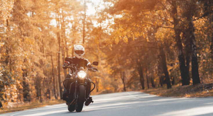 male-biker-riding-shiny-black-motorcycle