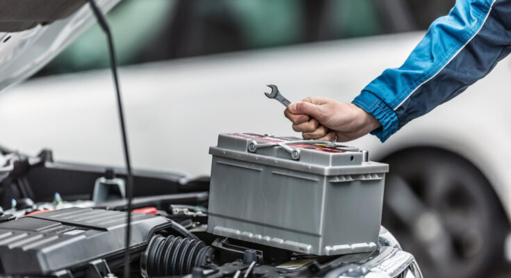 Mechanic Holds Key Car Battery With Engine Trunk Car Open